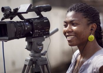 Female African journalist with video camera