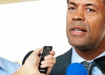 Mature African man answering to journalists during a press conference