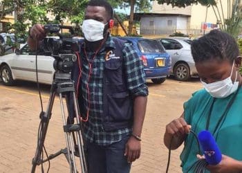 Two African journalists with a video camera