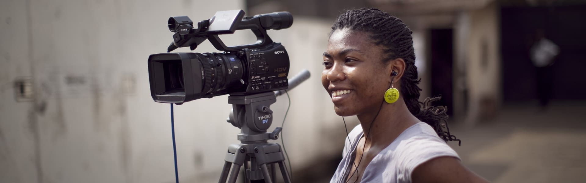 Female African journalist with video camera