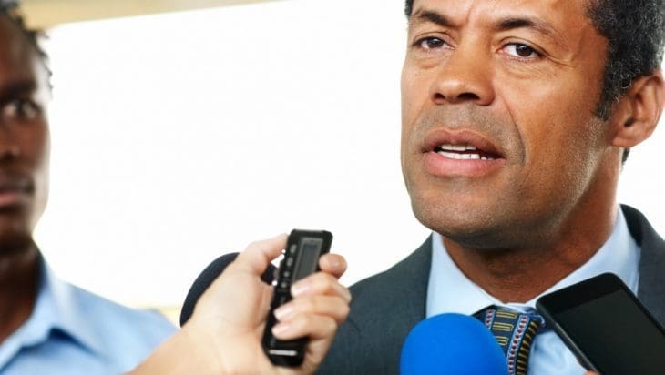 Mature African man answering to journalists during a press conference