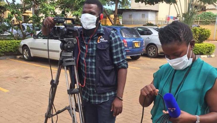 Two African journalists with a video camera